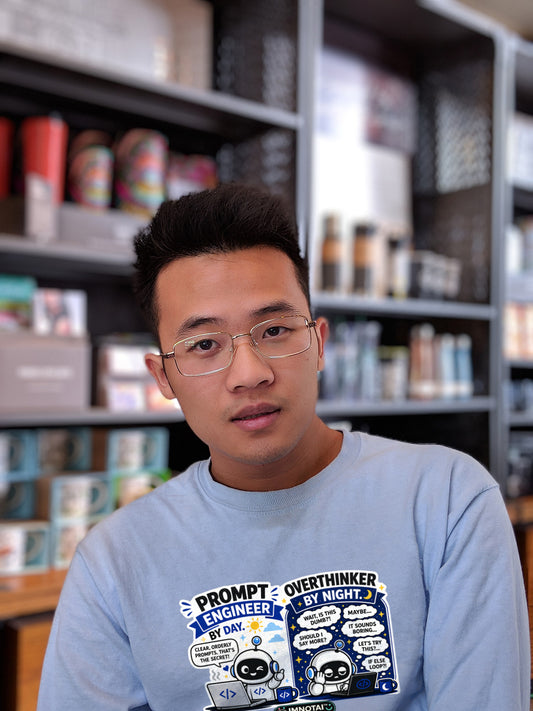 Person wearing a shirt with text and graphics in a bookstore setting